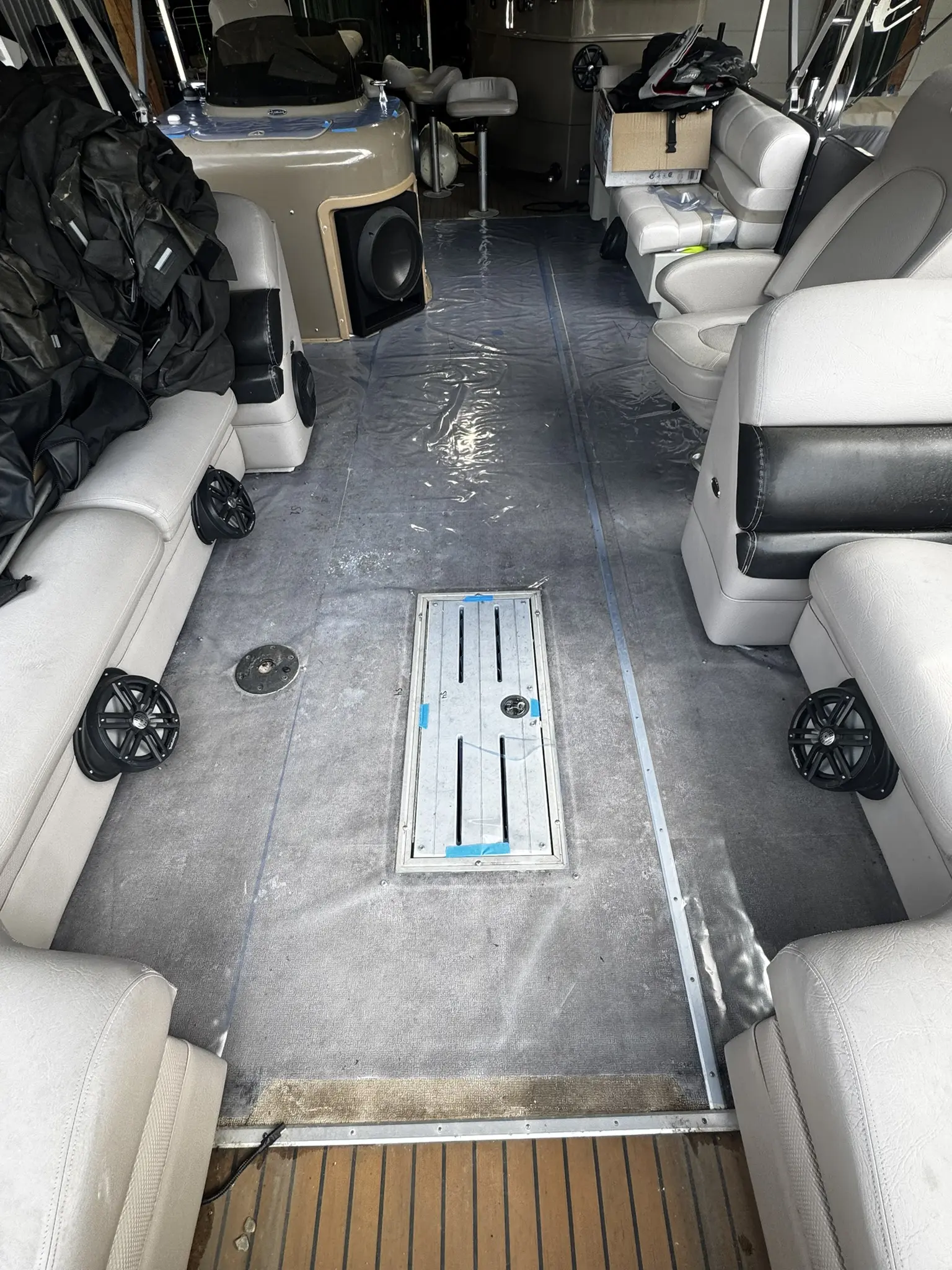 Boat interior with seating and speakers visible.