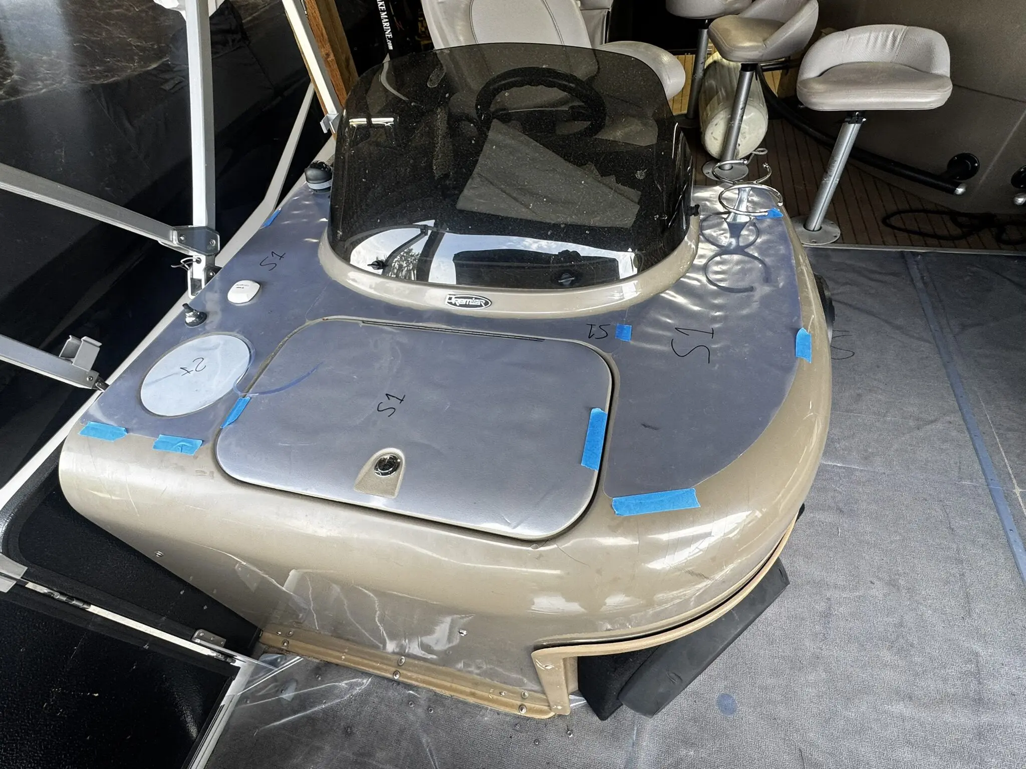Boat helm with covered controls and seating.