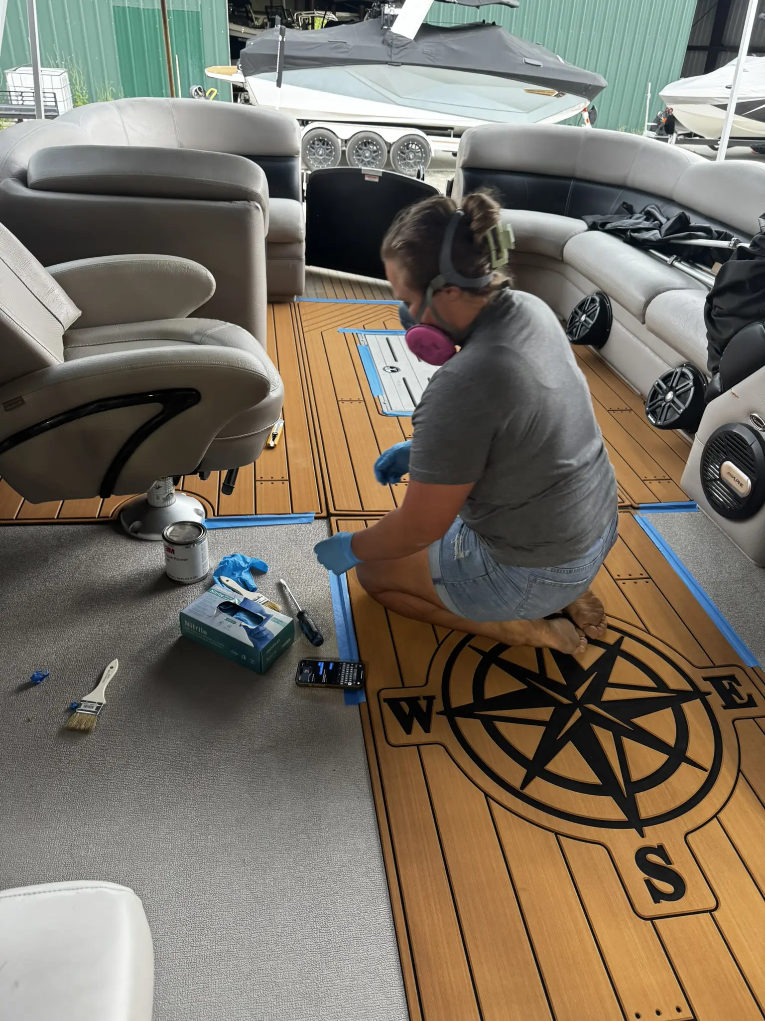 Person working on boat interior flooring.