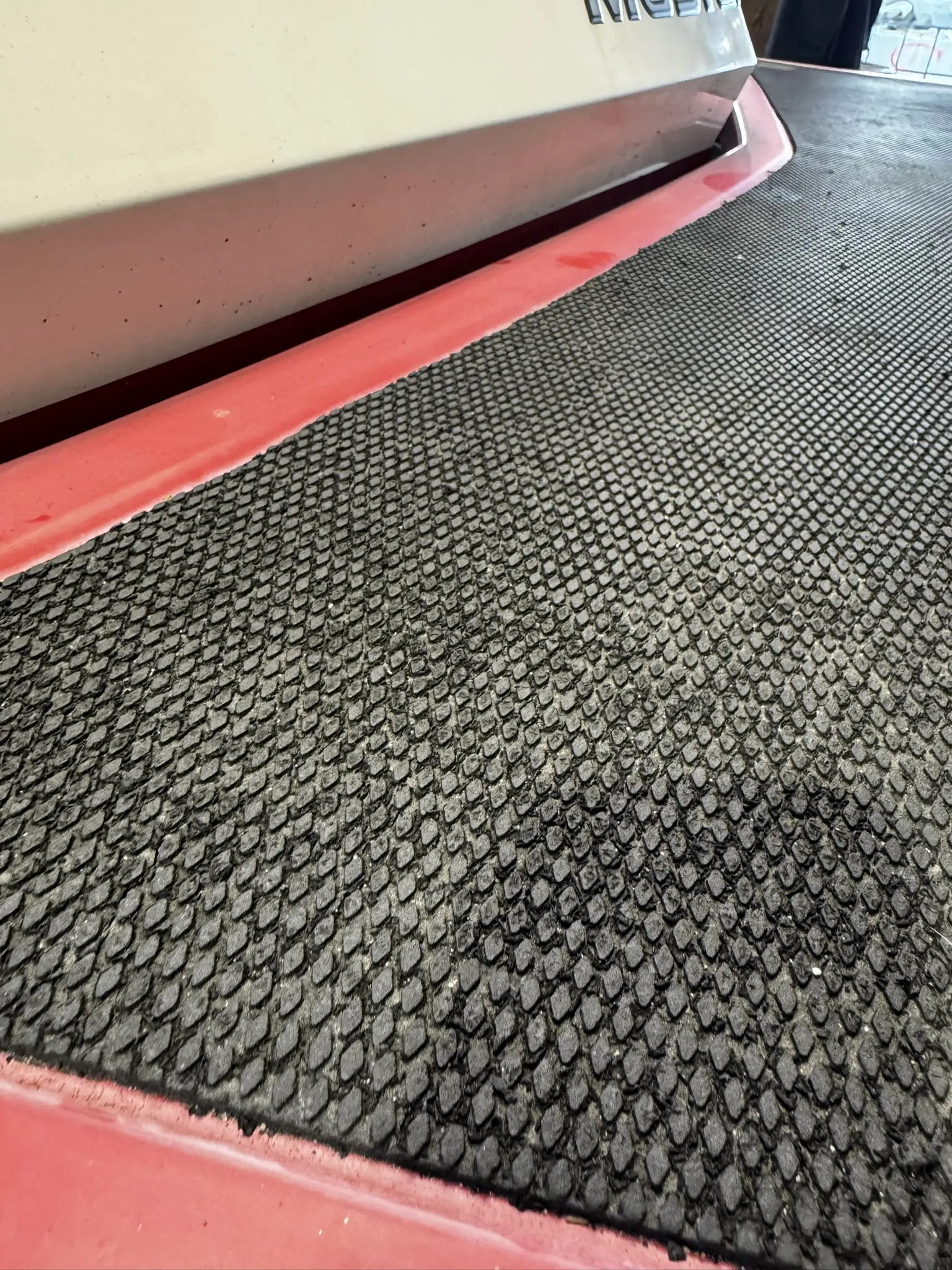 Textured rubber surface on red equipment.