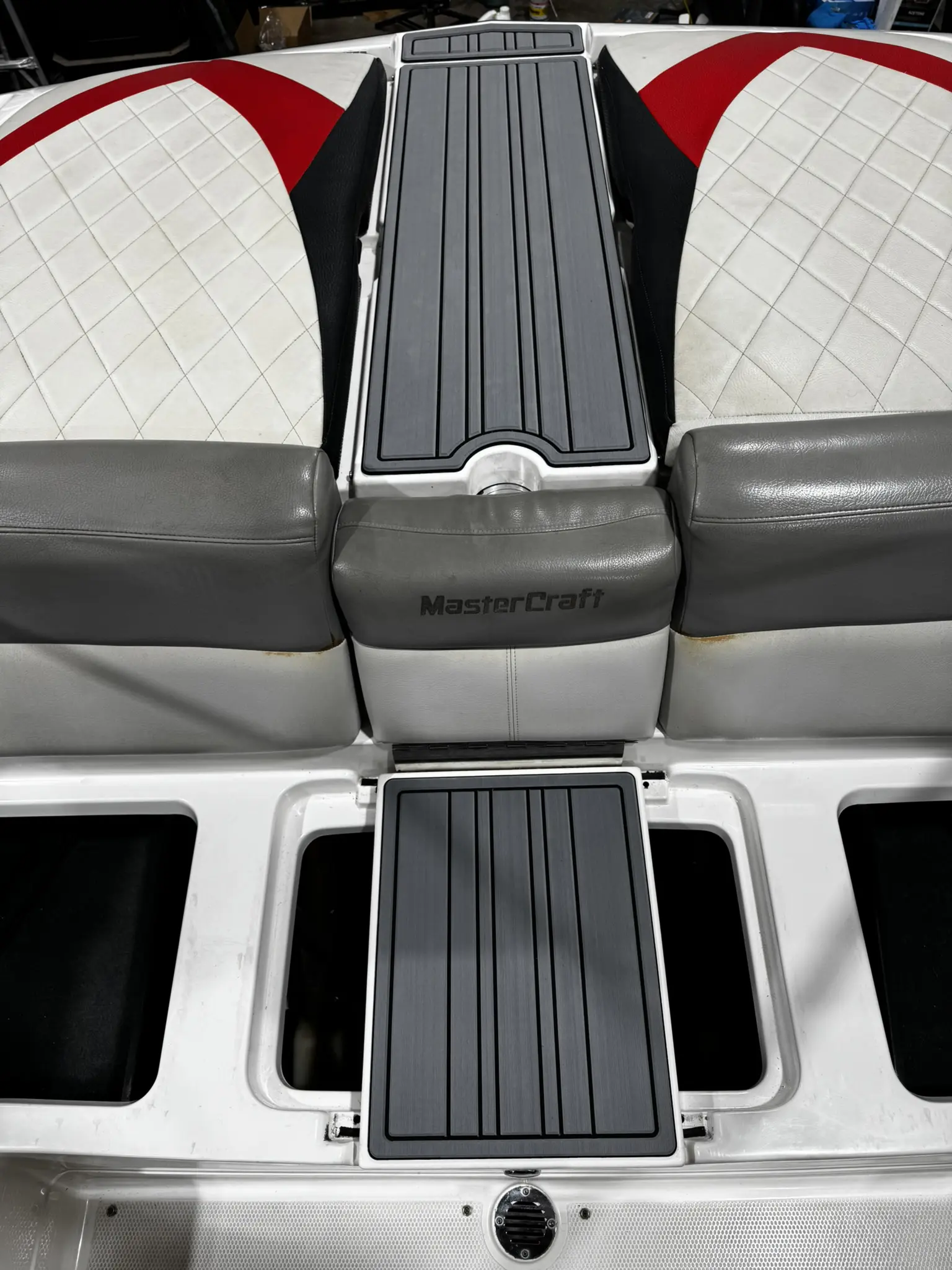 Boat seating with storage compartments open.