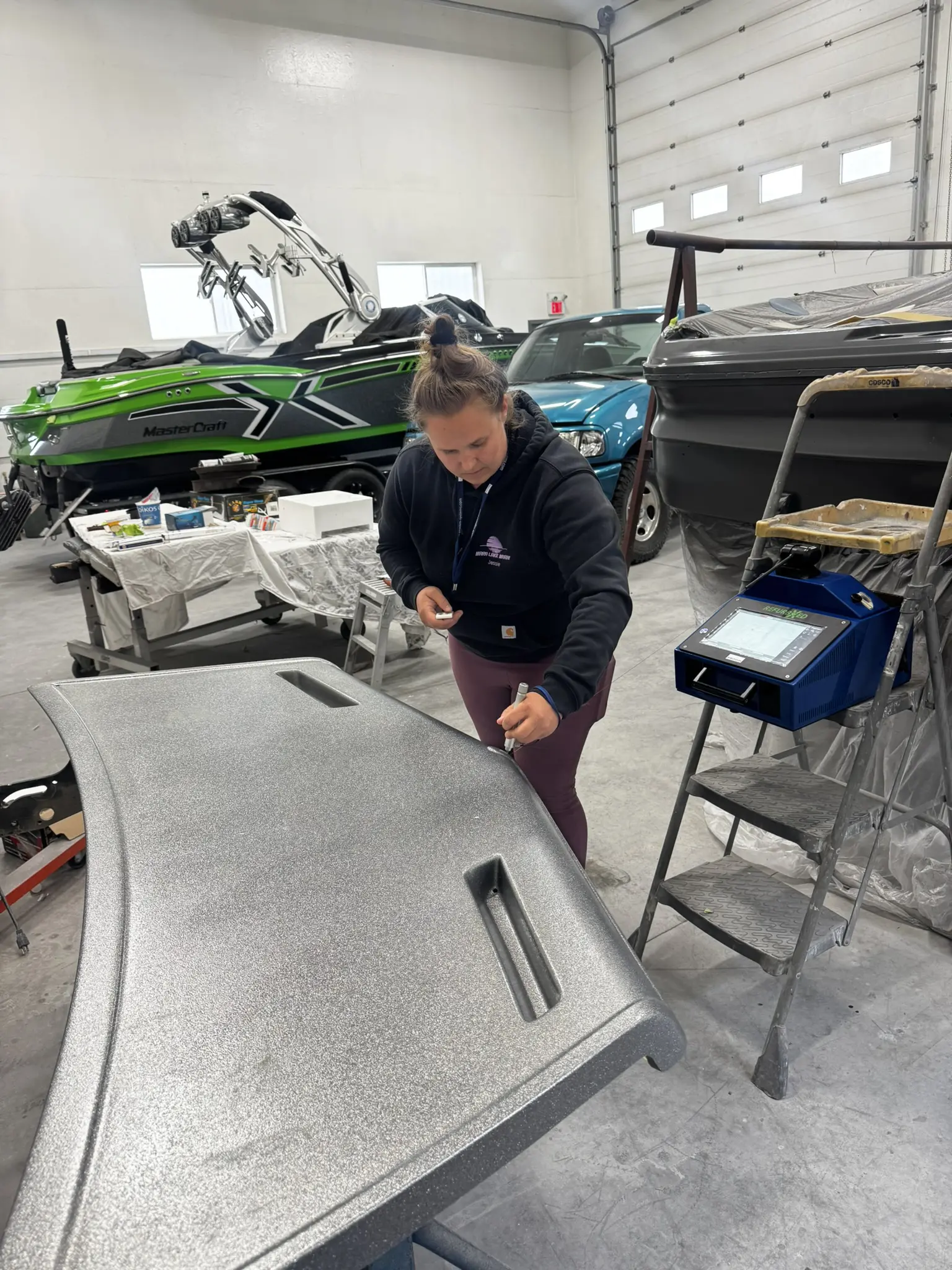 Person working in a boat repair shop.